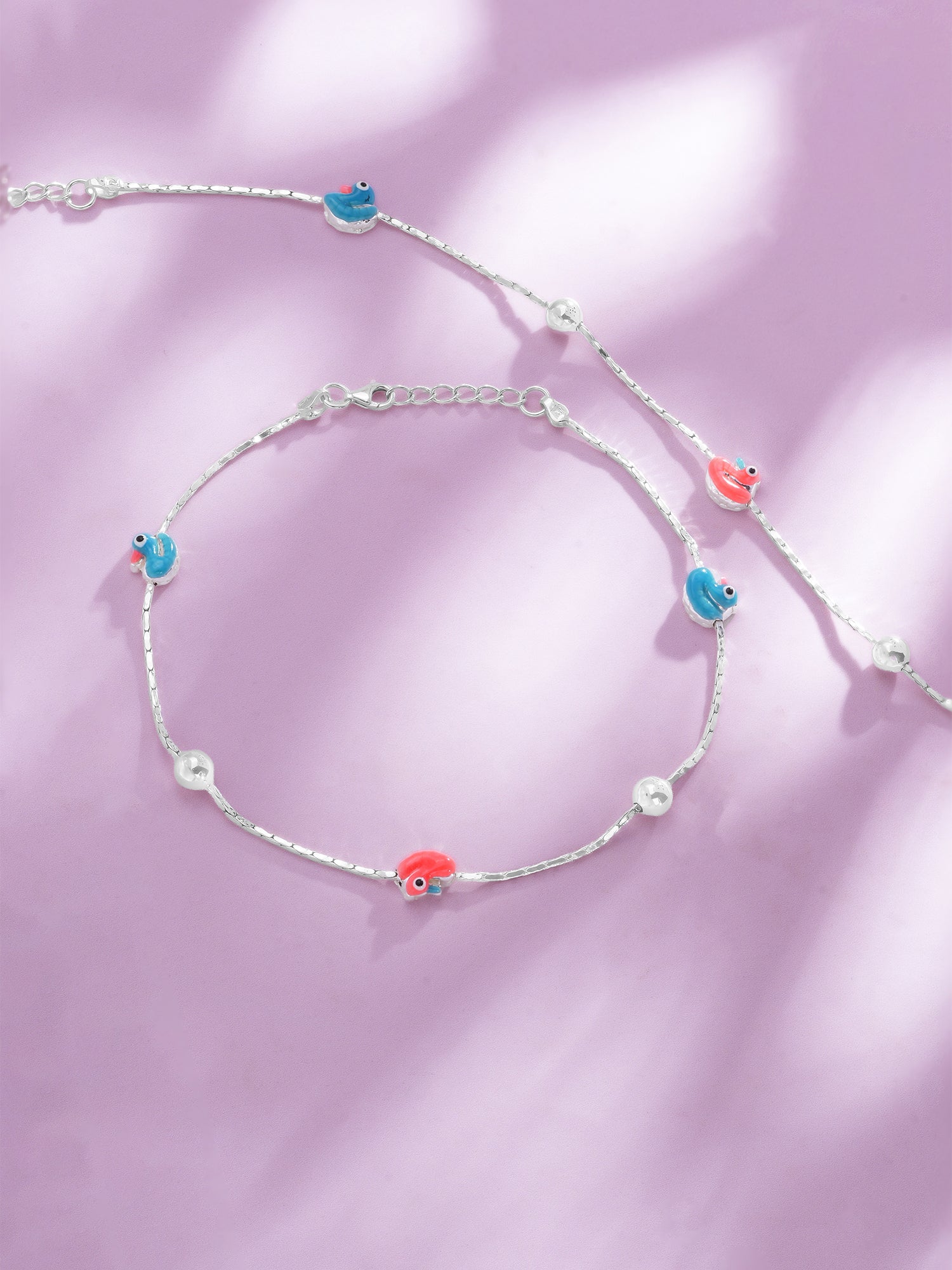 Close up of SIJA Duck Glow Anklet showing orange and peacock green enamel duck charm crafted in sterling silver