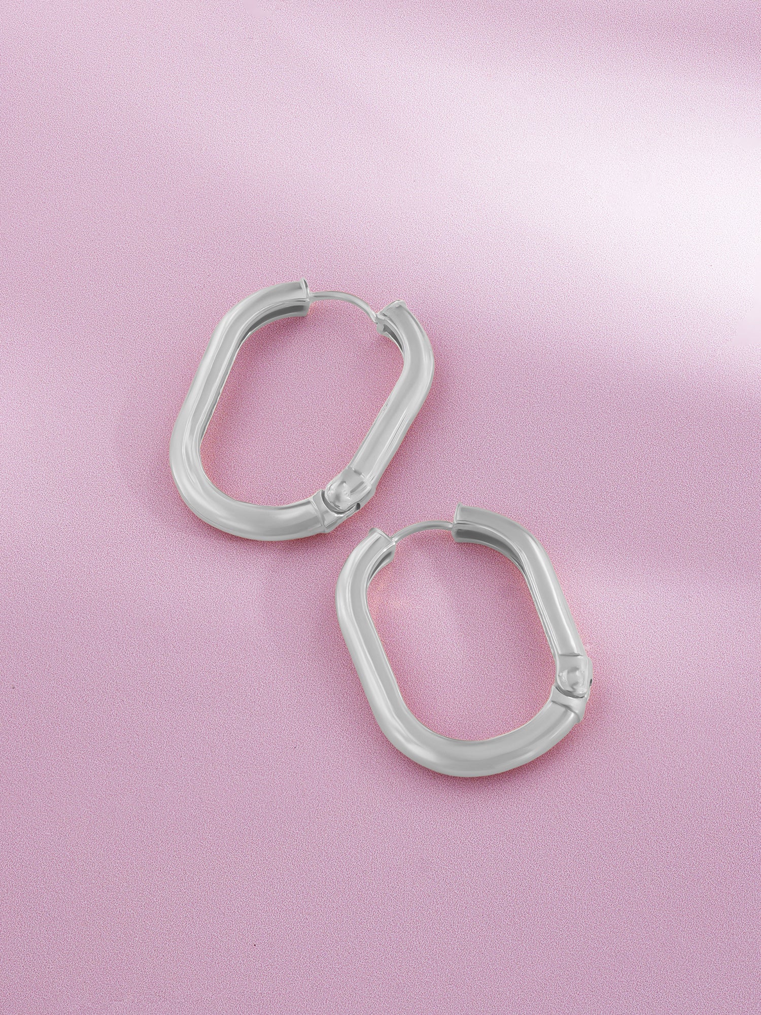 Detailed close up of SIJA 925 Silver Sleek Oval Hoop Earrings showing sleek oval hoop design and handcrafted silver finish